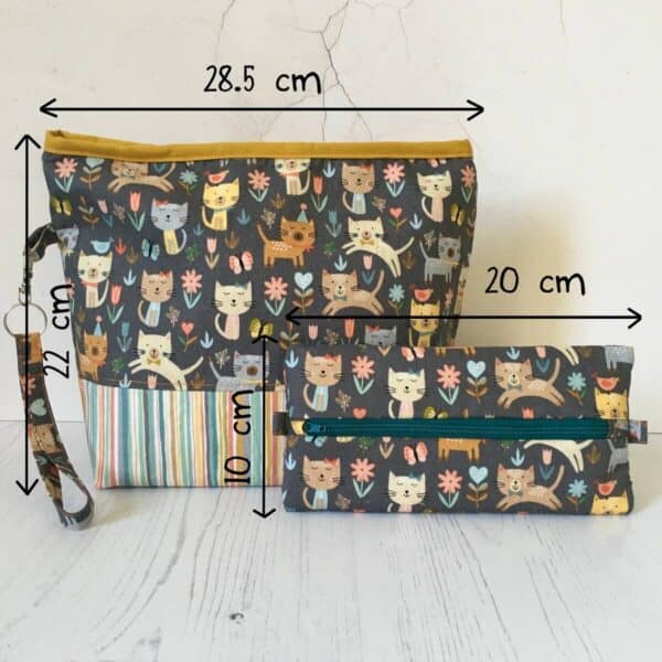 A very cute set of knitting project bag and notions pouch in a cat themed fabric, with measurements in the image for reference