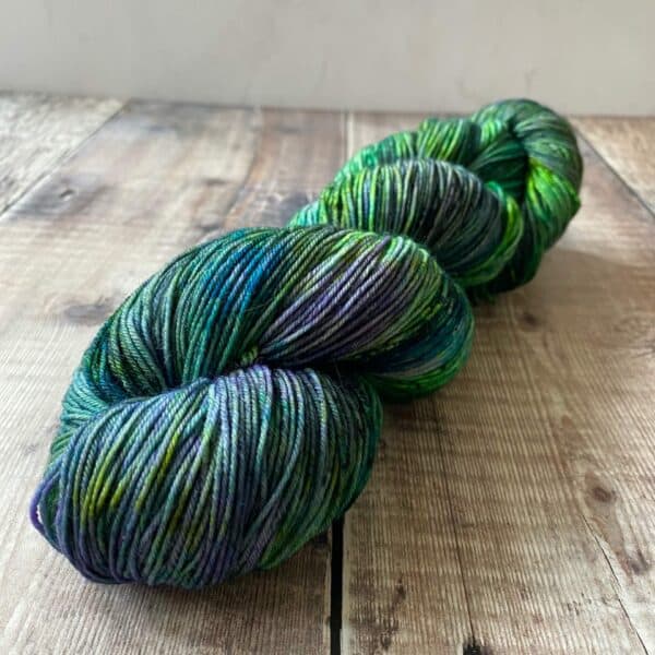 Green speckled hand dyed yarn on tabletop