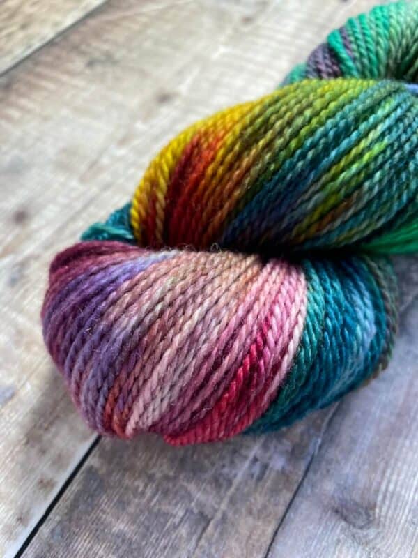 Detail of hand dyed jewel tone rainbow yarn in sock weight