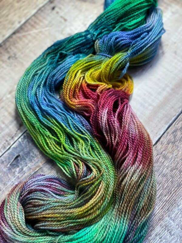 Another view of unskeined jewel tone sock yarn on table